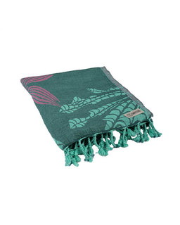 Green towel with tassels and a brand label on a white background