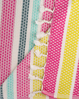 Close-up of a colorful fabric with patterns and tassels.