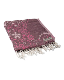 Pink and purple patterned towel with white fringe on a white background