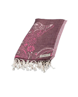 Purple patterned towel with white tassels on a white background