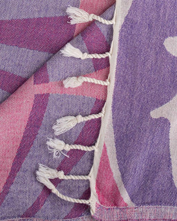 Close-up of a purple and pink patterned fabric with tassels