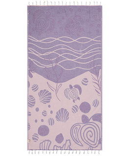 Towel with sea-themed design featuring shells and waves on a white background