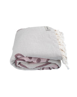 Folded towel with tassels on a white background