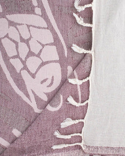 Close-up of a textured fabric with white floral patterns on a purple background