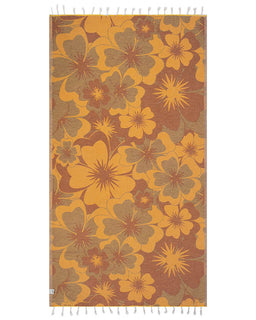 Floral patterned towel with orange and brown colors on a white background
