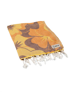 Yellow and brown patterned towel with white tassels on a white background