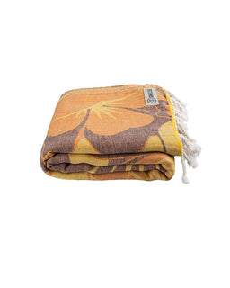 Folded towel with leaf pattern on a white background