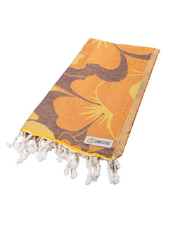 Orange and brown patterned towel with tassels on a white background