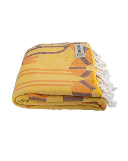 Yellow towel with purple patterns and white tassels on a white background