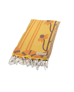 Yellow towel with floral design and tassels on a white background