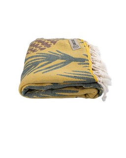 Folded blanket with floral pattern and tassels on a white background