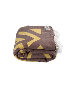 Folded towel with yellow patterns on a white background