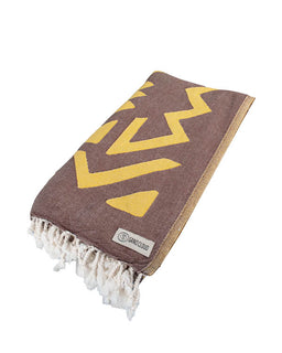 Brown towel with yellow zigzag pattern on a white background