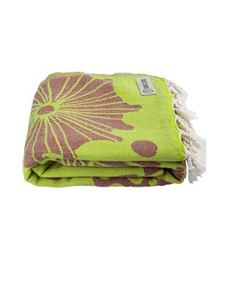 Green and brown patterned towel with a brand label on a white background