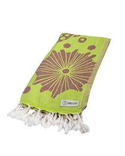 Green towel with purple floral pattern and white tassels on a white background