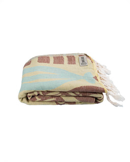 Folded towel with striped pattern and tassels on a white background