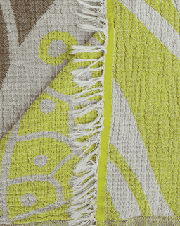 Close-up of a textured fabric with geometric patterns and fringes.