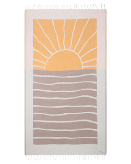 A turkish organic cotton beach towel with a sunset design, featuring a large sun in orange behind a grey wave pattern, with a white border at the top and twisted tassels at the bottom.