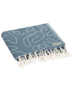 Blue patterned towel with white fringe on a white background