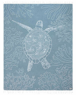 Blue towel with white turtle and coral pattern