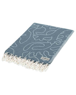 Blue patterned towel with white fringe on a white background
