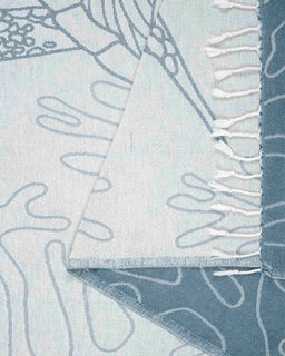 Close-up of a textured fabric with abstract patterns in blue and white.