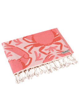 Pink towel with crab pattern and white fringe on a white background