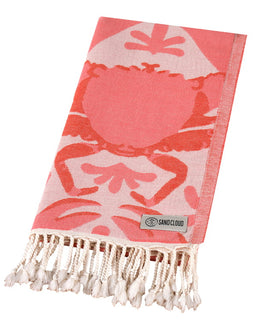 Pink towel with crab design and 'Sand Cloud' label on a white background