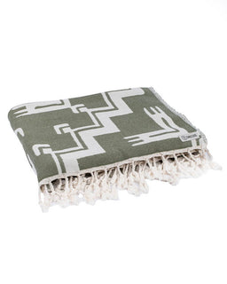 Green and white patterned towel with fringes on a white background