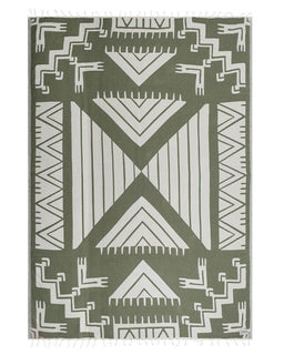 Green and white geometric patterned rug on a plain background