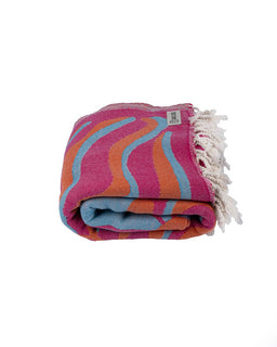 Colorful towel with wavy pattern and tassels on a white background