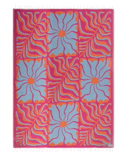 Colorful patterned blanket with pink, blue, and orange design on a white background