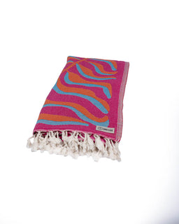 Colorful towel with wavy pattern and tassels on a white background