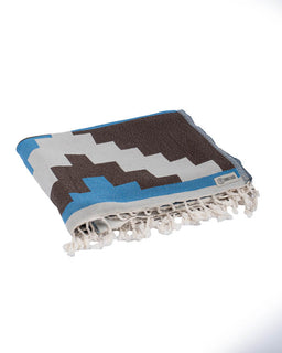 Folded towel with geometric pattern on a white background