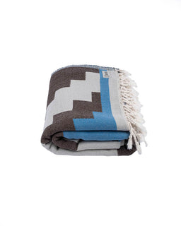 Folded blanket with geometric pattern on a white background