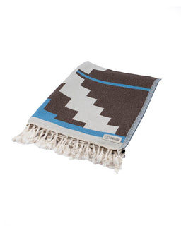 Woven blanket with geometric pattern on a white background