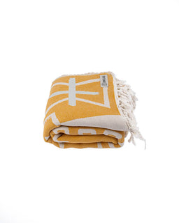 Yellow blanket with white geometric pattern on a white background