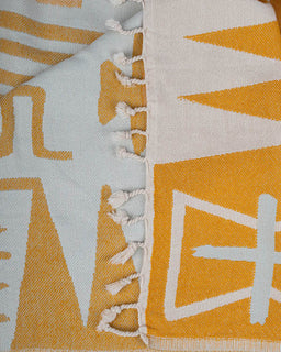 Close-up of a fabric with geometric pattern and tassels