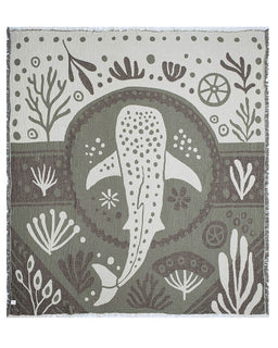 Blanket with whale design and underwater patterns on a gray background