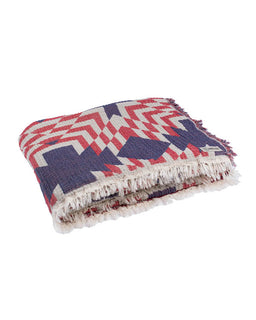Folded blanket with geometric pattern on a white background