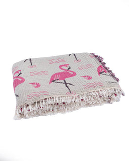 patterned blanket with pink flamingo design on a white background