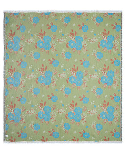 Floral patterned blanket with blue flowers on a green background