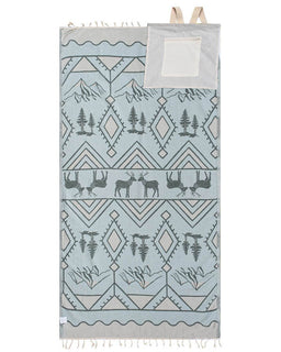 Towel with nature-themed design featuring trees, deer, and geometric patterns on a light blue background.