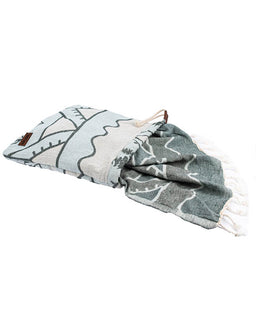 Folded towel with leaf pattern on a white background