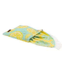 Folded blanket with lemon pattern on a white background