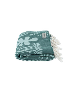 Green towel with white floral patterns and fringes on a white background