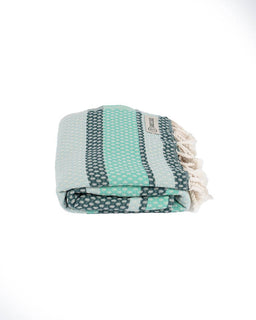 Folded towel with green and gray pattern on a white background