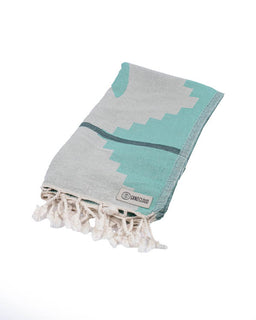 Turquoise and gray patterned towel with tassels on a white background