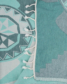 Teal and gray patterned towel with tassels