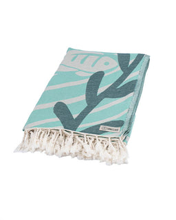 Turquoise towel with leaf pattern and white fringe on a white background